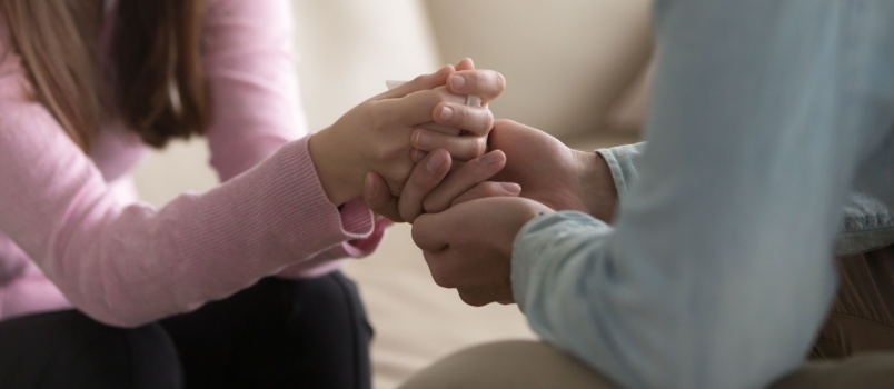Couple holding each other hands