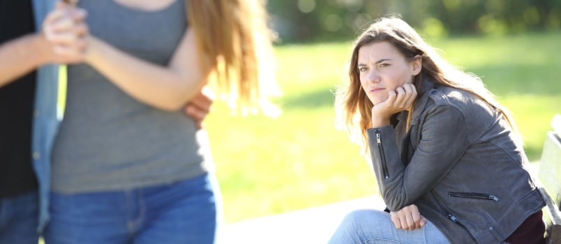 Jealous girl sitting on bench