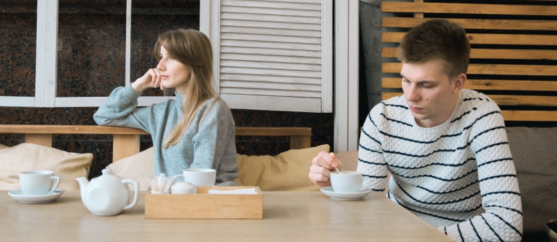 Young couple having conflicts in cafe
