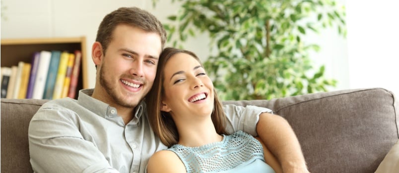 Couple hugging in front of camera