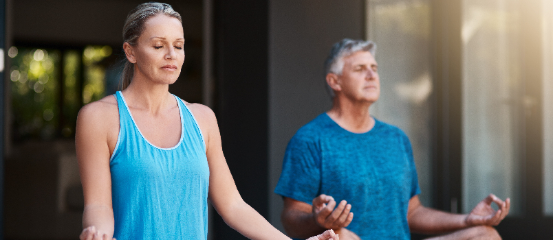 Old couple doing yoga together
