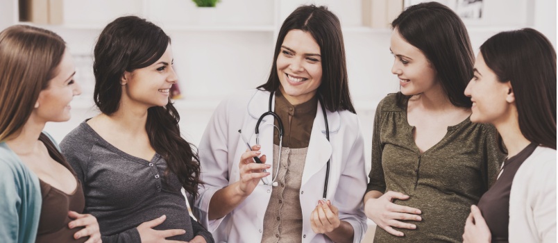 Pregnant woman listening to doctor
