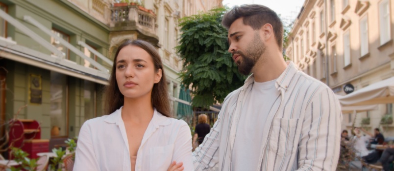 Annoyed girl by his boyfriend's behaviour