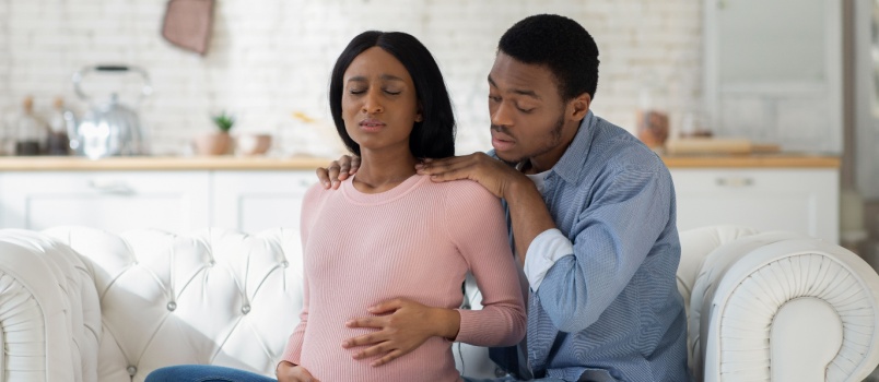 Husband trying to help his wife during pregnancy
