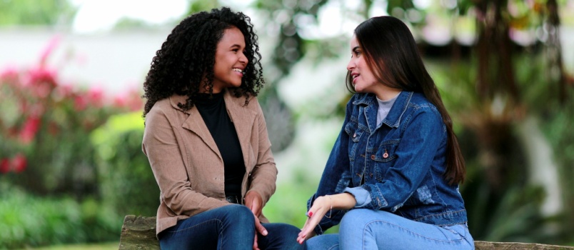 Two diverse girls talking to each other