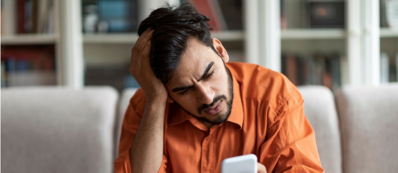 Anxious man using his phone
