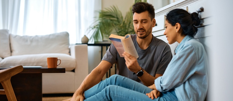 Smiling couple reading book
