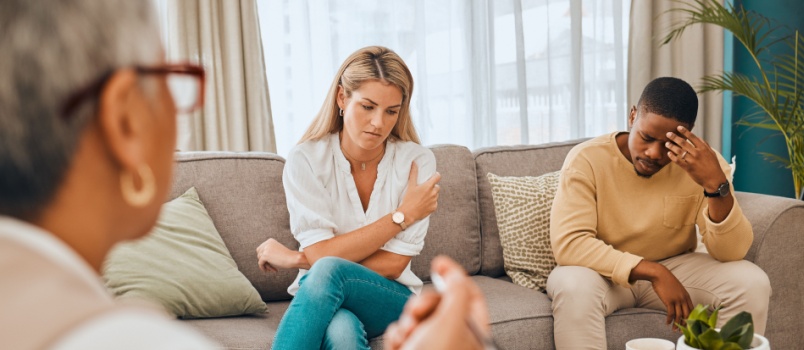 Young couple talking to psychologist