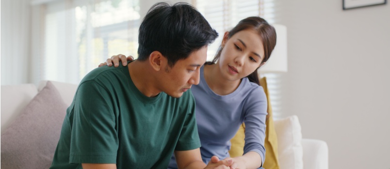 Woman comforting sad man