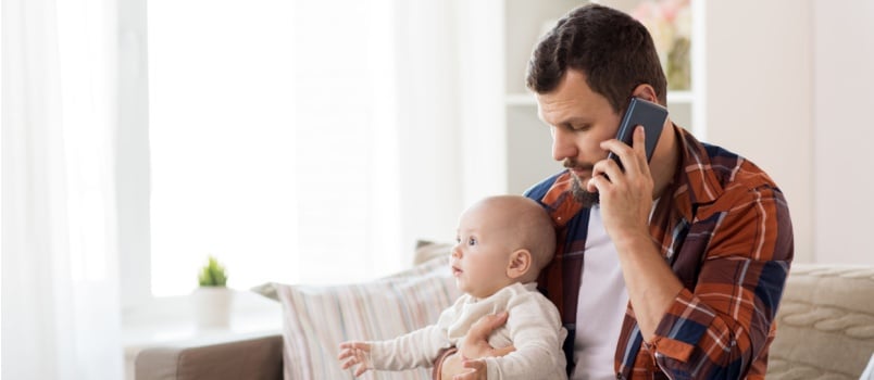 Father talking on call while taking care of kid