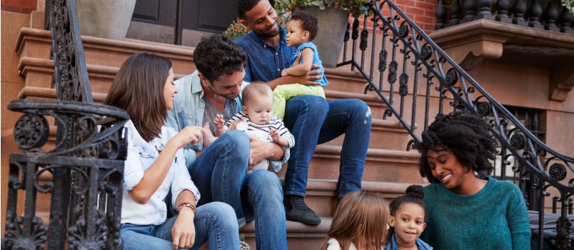 Two families kids sitting infront of door