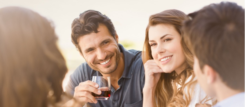 Happy young friend enjoying drinks