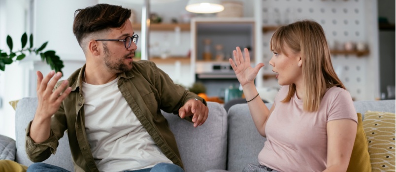 Couple arguing sitting on couch