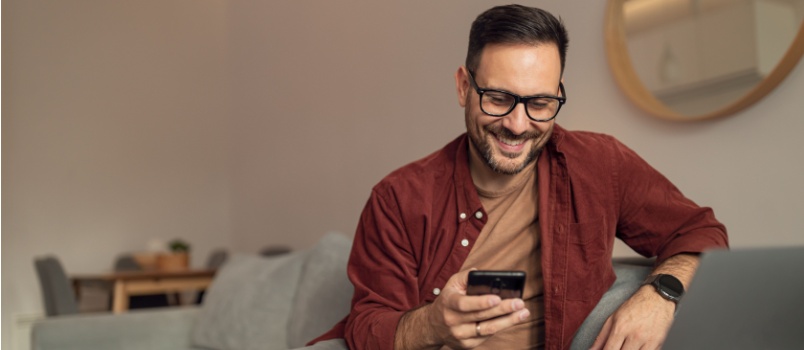 Smiling man using smartphone