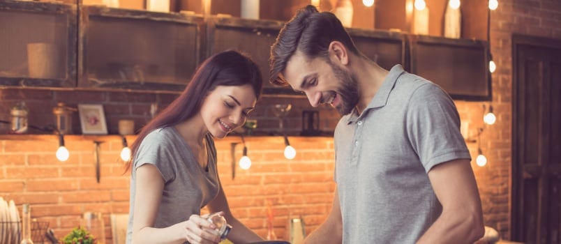 Young couple working in kitchen