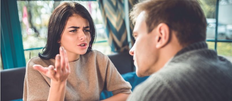 Young couple having conflicts in cafe