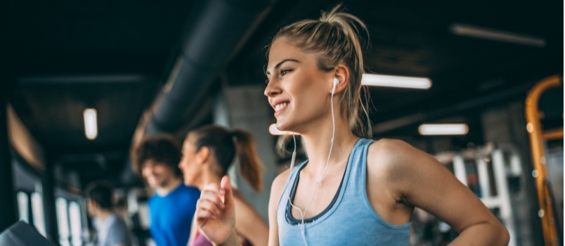 Young woman running on treadmill