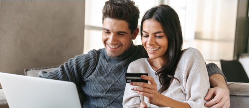 Happy couple doing online shopping