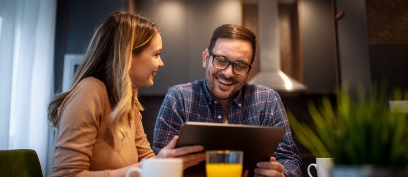 Young couple laughing while having breakfast