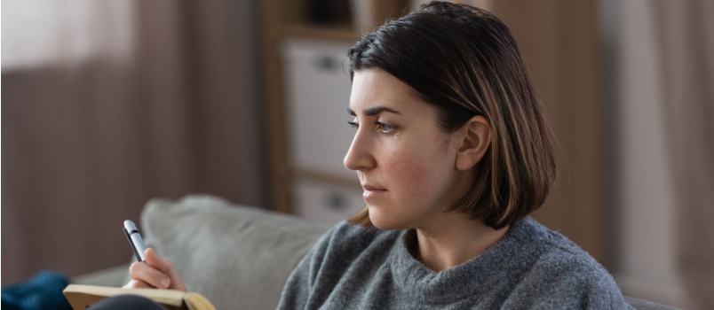 Depressed woman sitting on couch
