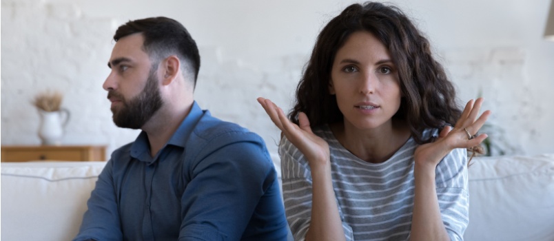 Angry couple sitting on couch