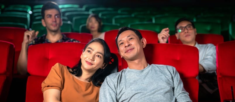Happy couple watching movie