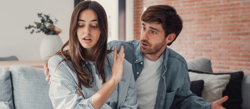 Depressed couple sitting on couch