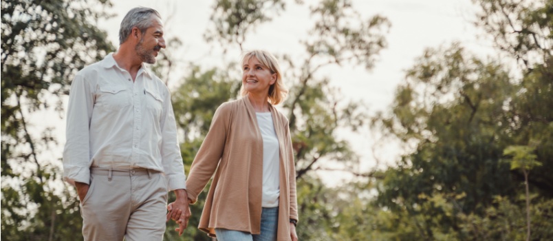 Elderly vouple walkinig in the park