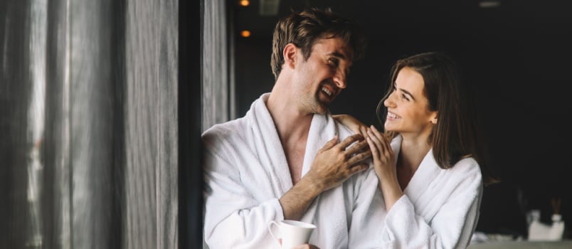 Happy married couple relaxing in wellness spa