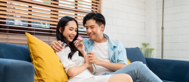 Young man surprise woman with the rose