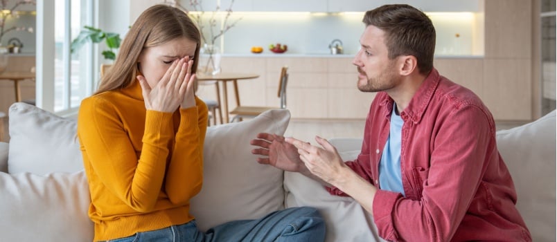 Man talking to woman while she is crying