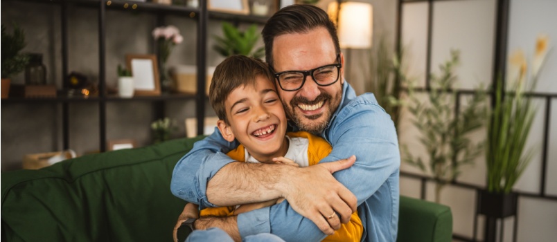 Happy dad hugging his son