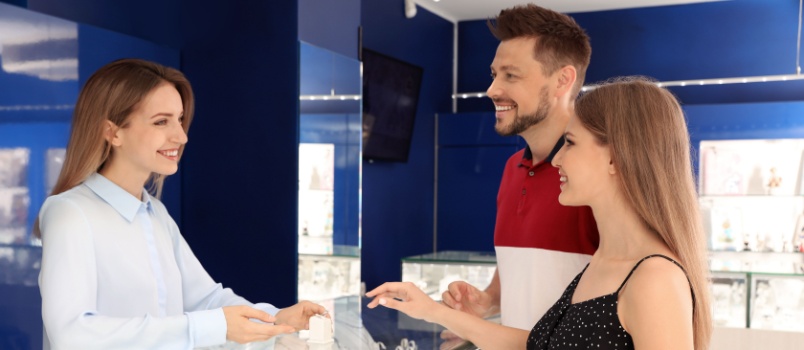 Young couple choosing engagement ring