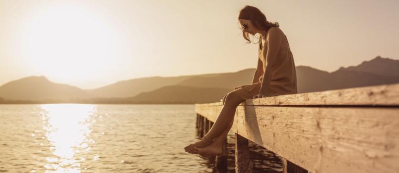 Woman sitting on bridge