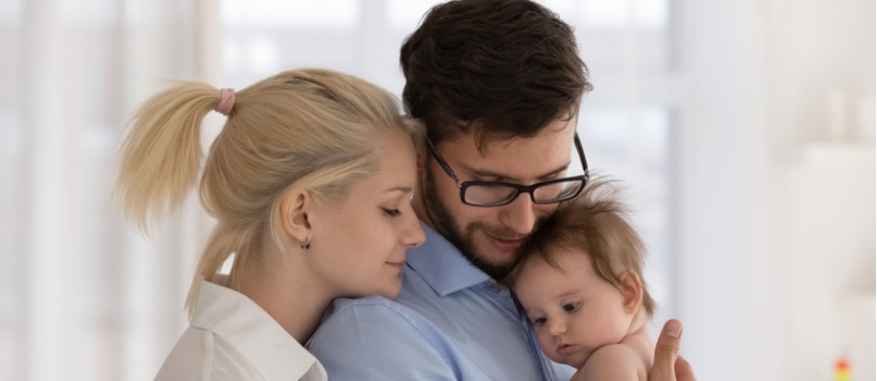 Young couple enjoying with baby
