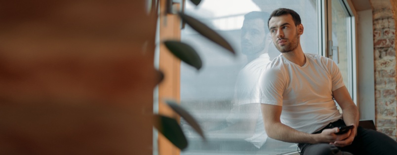 Man sitting beside window