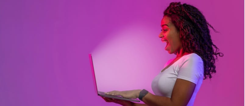 Surprised woman looking at laptop