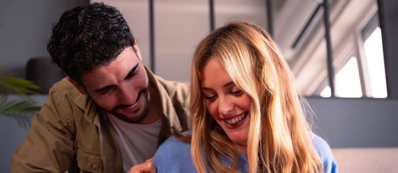 Happy man giving gift to woman