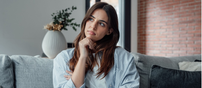 Think full woman siting on couch