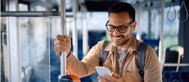 Happy man texting on smartphone