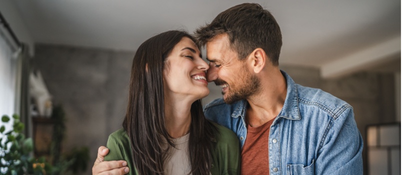 Young couple standing smiling together