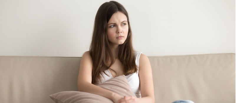 Young woman sitting on couch