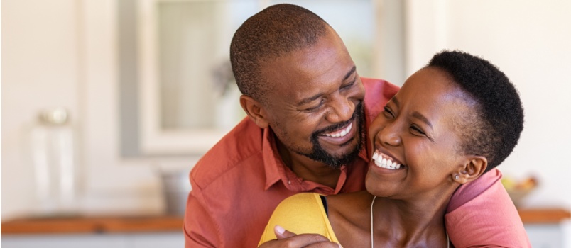 Couple embracing on couch