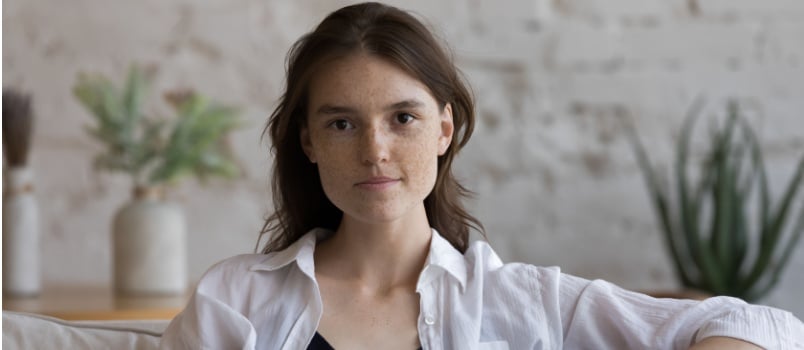 Serious freckled woman