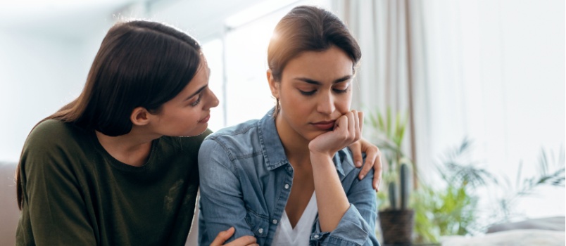Young woman supporting another woman