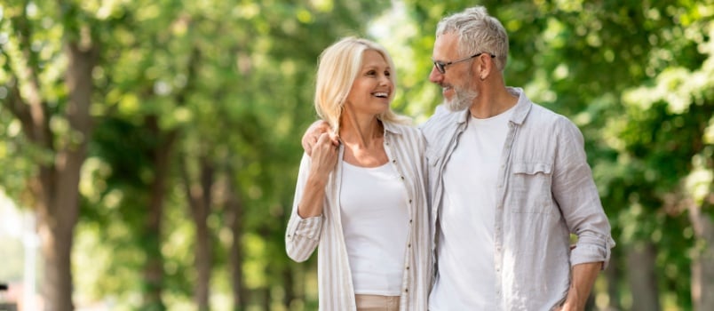 young mature couple walking in garden