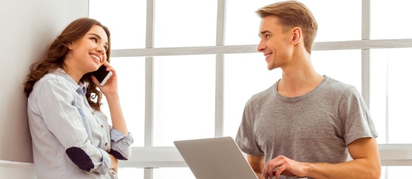 Couple using laptop while talking
