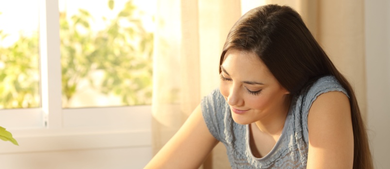 Happy girl writing letter