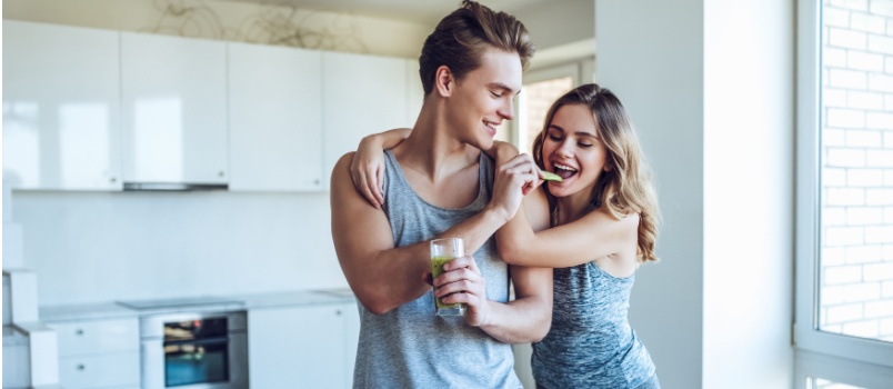 Happy sporty couple having food