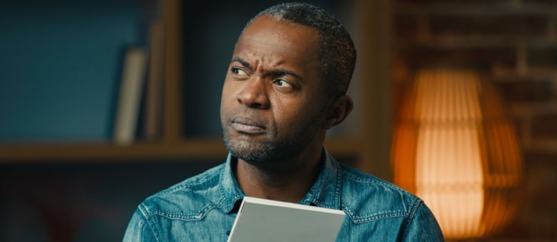 African man writing letter